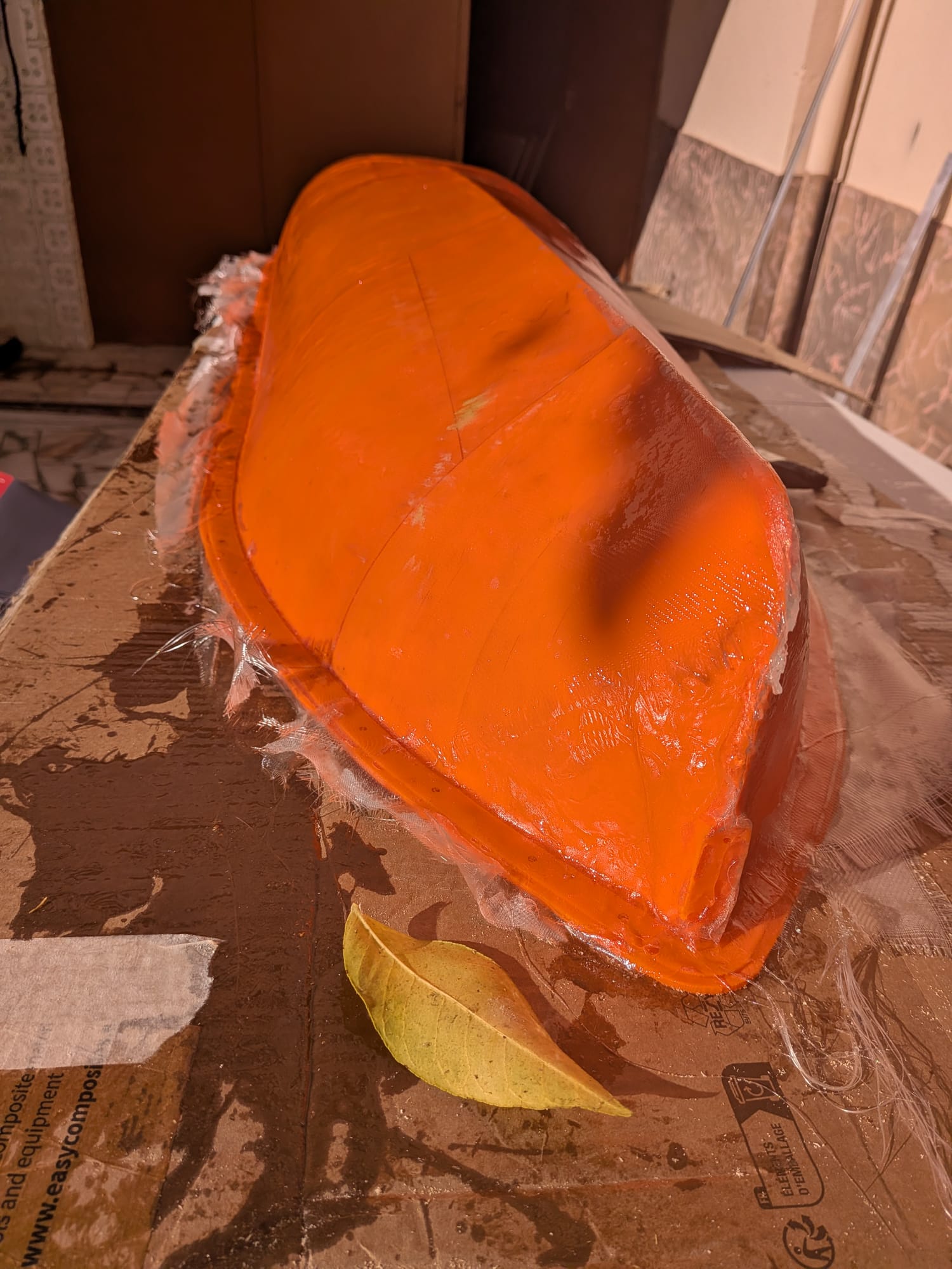 First layers of fiberglass going on the hull