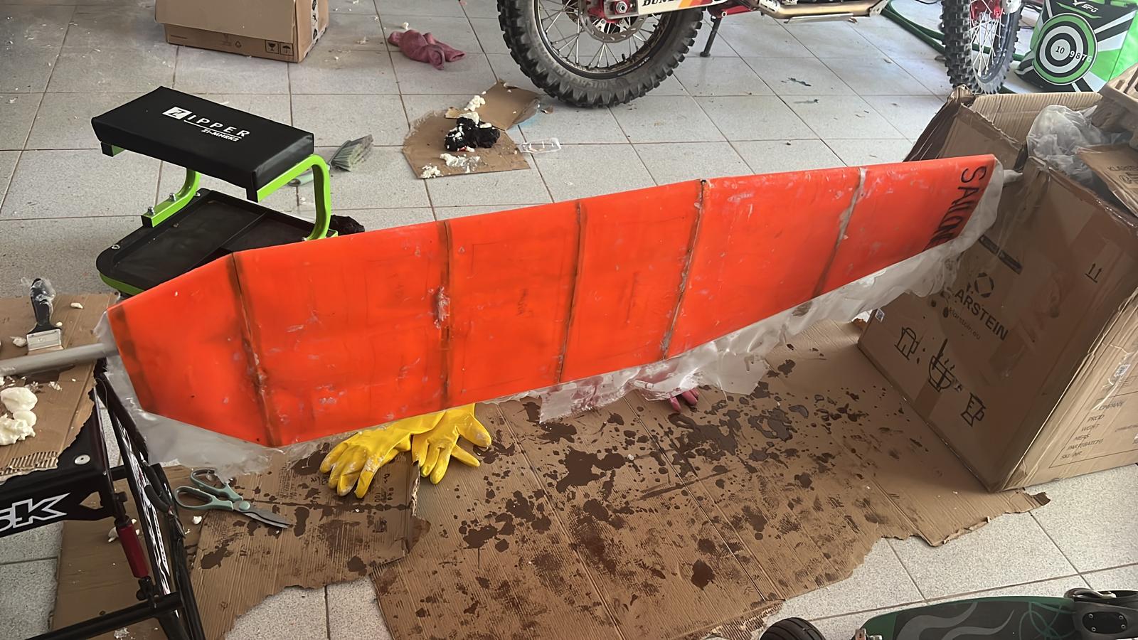 Laying fibreglass over the wing surface